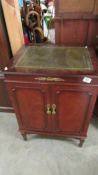 A record player in a mahogany cabinet.