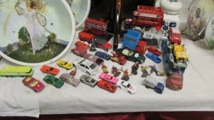 A mixed lot of play worn die cast cars.