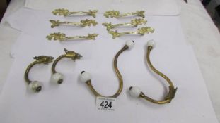 Four old coat hooks and a set of six ormolu drawer handles.