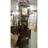 A modern brass faced Grandfather clock.