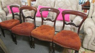 A set of four mahogany dining chairs.