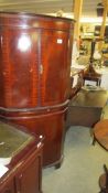 A mahogany free standing corner cupboard.