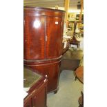 A mahogany free standing corner cupboard.