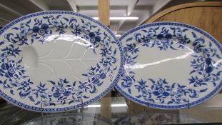 Two blue and white meat platters.