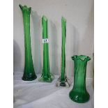 Three green glass spill vases and another green glass vase.
