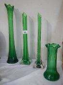 Three green glass spill vases and another green glass vase.