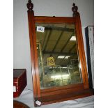 A mahogany framed mirror.