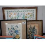 A framed and glazed cross stitch and two floral prints.