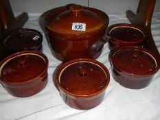 Six stoneware cooking pots.