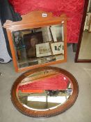 An oak framed mirror and one other.