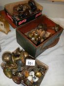 A mixed lot of old brass and other door and drawer knobs.