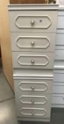 2 three drawer white bedroom chests.