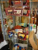 Three shelves of boxed and unboxed die cast model vehicles.