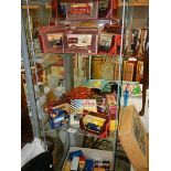 Three shelves of boxed and unboxed die cast model vehicles.