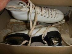 A boxed pair of vintage ice skates.