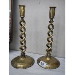 A pair of brass barley twist candlesticks.