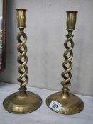 A pair of brass barley twist candlesticks.