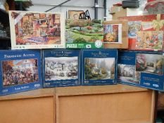 A quantity of jigsaw puzzles including Kinkade.