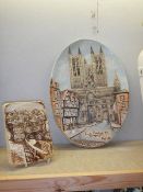 An oval wall plaque depicting Lincoln Cathedral signed Roy Fisk and another Lincoln wall plaque.