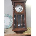 A 1930's oak wall clock.