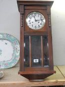 A 1930's oak wall clock.