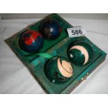 Two pairs of oriental metal balls.