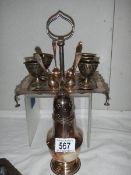 A silver plate egg cup stand and a silver plate sugar sifter.