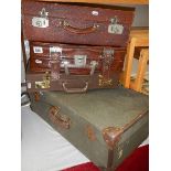 Two old suitcases and two briefcases.