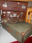 Two old suitcases and two briefcases.