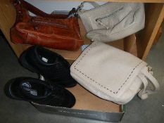 A pair of new golf shoes and three vintage hand bags.