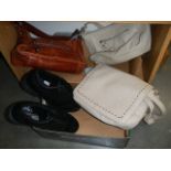 A pair of new golf shoes and three vintage hand bags.