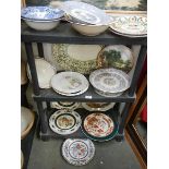 Three shelves of assorted plates.