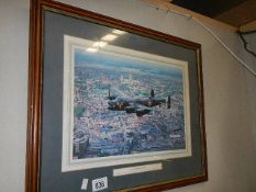 A framed and glazed print entitled 'Lancaster over Lincoln'.