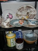 Two shelves of assorted plates, jars etc.