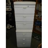 A pair of three drawer white bedside chests.