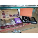 A cased vanity set and one other item.