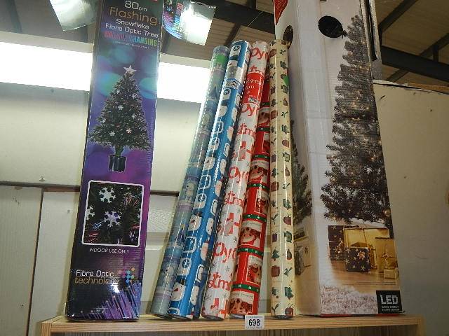Two boxed Christmas trees and a quantity of wrapping paper.