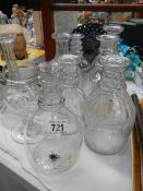 Eight glass decanters (missing stoppers) and a vase,