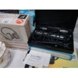 A boxed vintage microphone and a boxed pair of head phones.