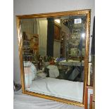 A gilt framed bevel edged mirror.