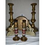 A pair of brass candlesticks, another pair with multicoloured stems and three other brass items.
