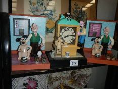 Three Wallace and Gromit clocks.