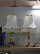 A pair of 20th century brass table lamps with shades.