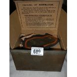 An unused WW2 gas mask in metal container.