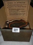 An unused WW2 gas mask in metal container.