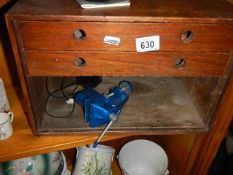 A small wooden tool chest and a small vice.