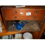 A small wooden tool chest and a small vice.