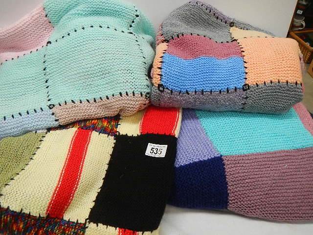 Four knitted blankets.