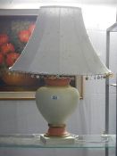 A ceramic table lamp with shade.