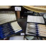 A cased set of fish knives and forks together with a cased set of fish knives.